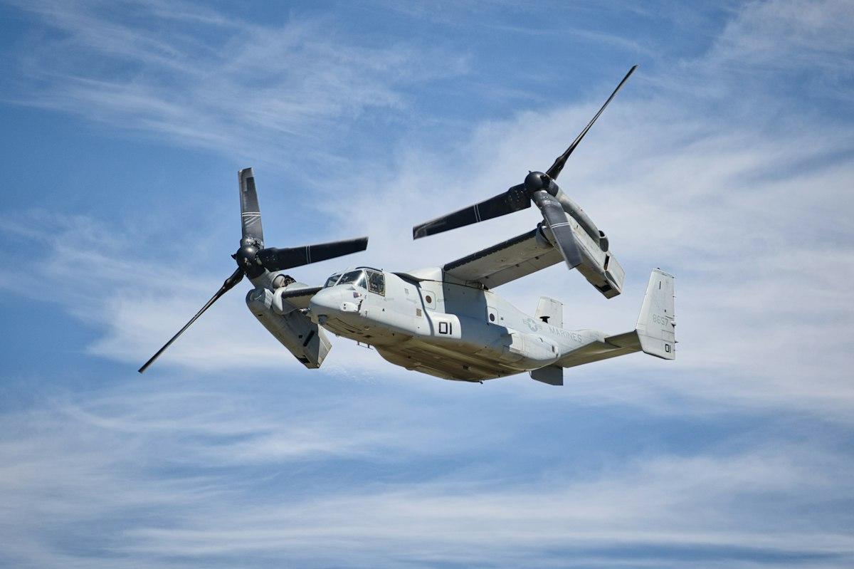 Tiltrotor aircraft in flight against a blue sky