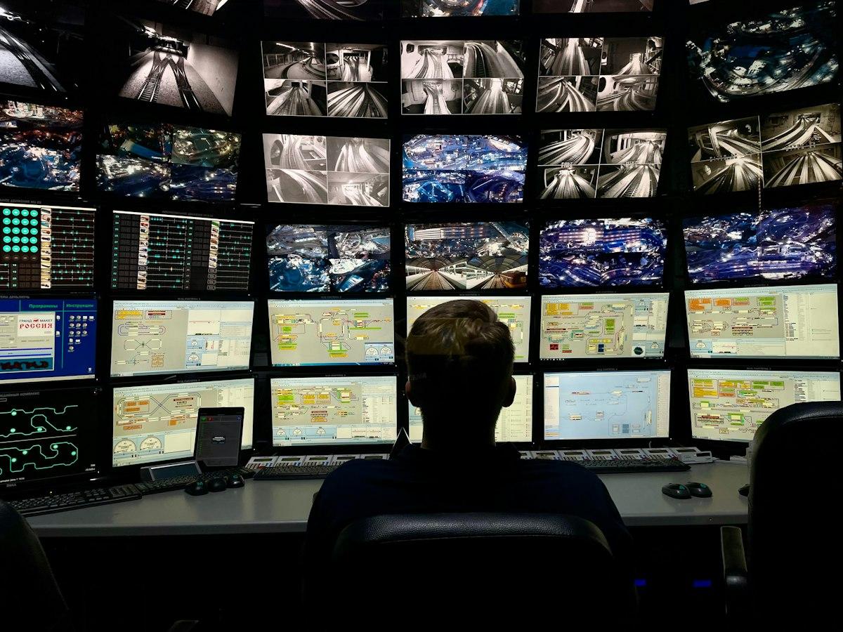 Operator in front of a wall of monitors